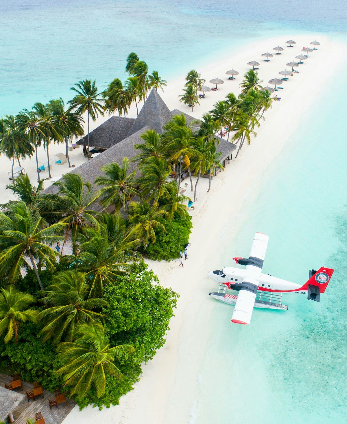 Cruise ship docked at a tropical Caribbean private island with white sand beaches