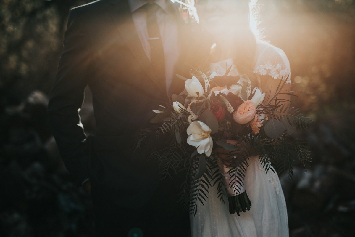 Bride and groom celebrating their destination cruise wedding on a ship balcony overlooking the ocean